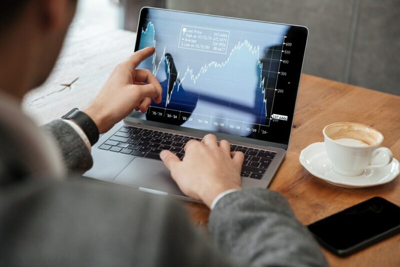 cropped image businessman sitting by table cafe analyzing indicators laptop computer 171337 5598 Cronos Asia